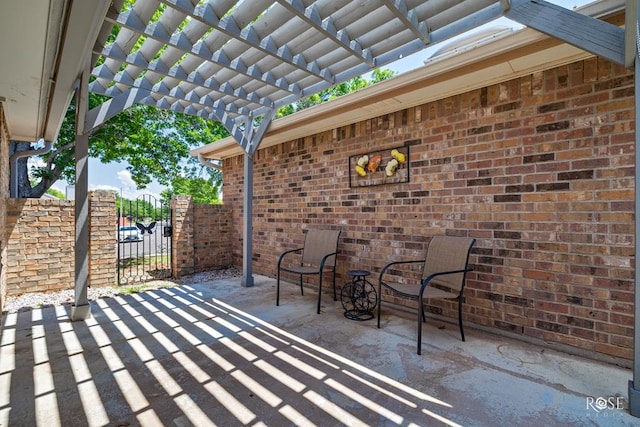 view of patio with a pergola and fence