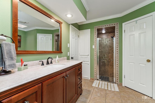 bathroom featuring a shower stall, ornamental molding, tile patterned floors, and vanity
