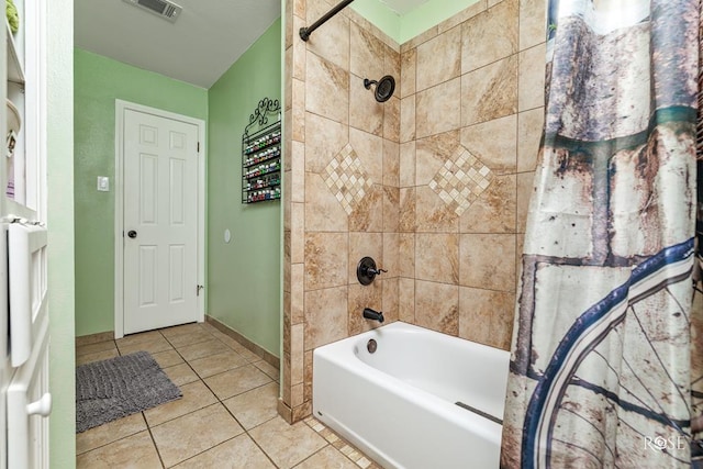 bathroom featuring shower / washtub combination, baseboards, visible vents, and tile patterned floors