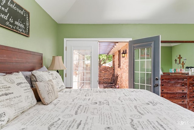 bedroom featuring vaulted ceiling and access to exterior