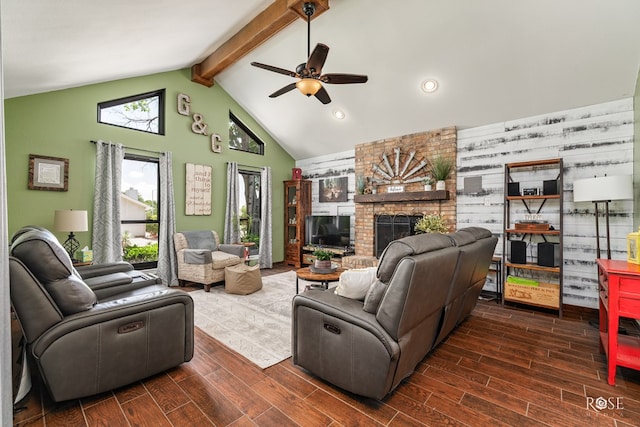living area featuring dark wood finished floors, beam ceiling, a ceiling fan, and a brick fireplace