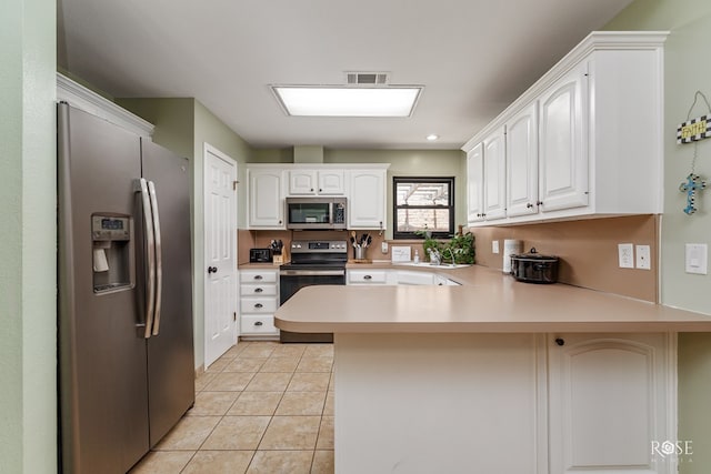 kitchen with a peninsula, light tile patterned floors, visible vents, light countertops, and appliances with stainless steel finishes