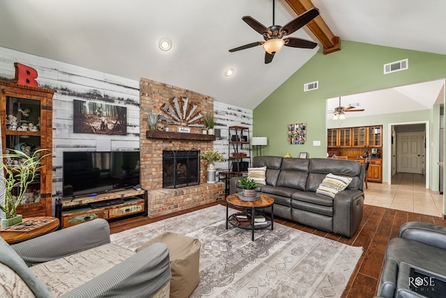 living area featuring visible vents, a ceiling fan, and beamed ceiling