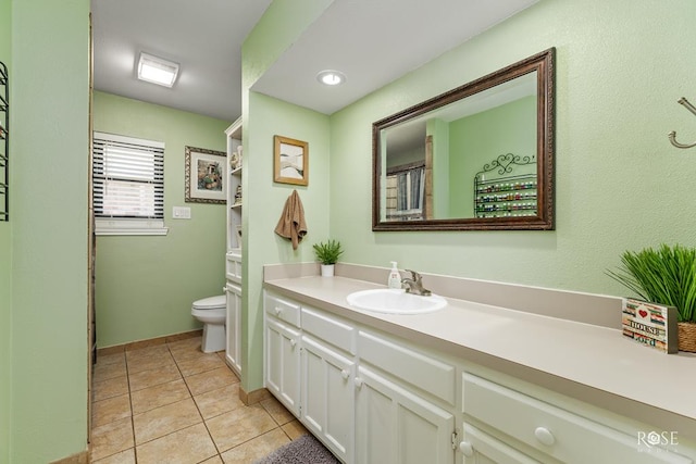 full bathroom with tile patterned floors, toilet, and vanity