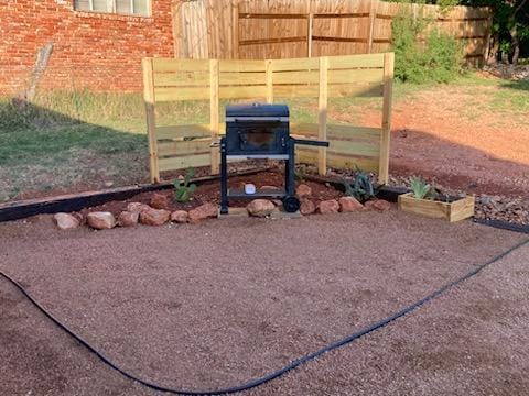 exterior space featuring brick siding and fence