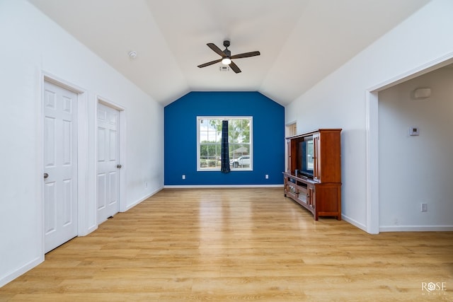 unfurnished living room featuring lofted ceiling, light hardwood / wood-style floors, and ceiling fan