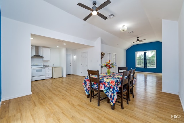 dining space with lofted ceiling, light hardwood / wood-style flooring, and ceiling fan