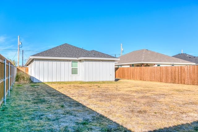 rear view of property with a yard