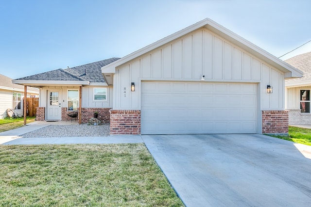 view of front of house with a garage, a front yard, and a porch