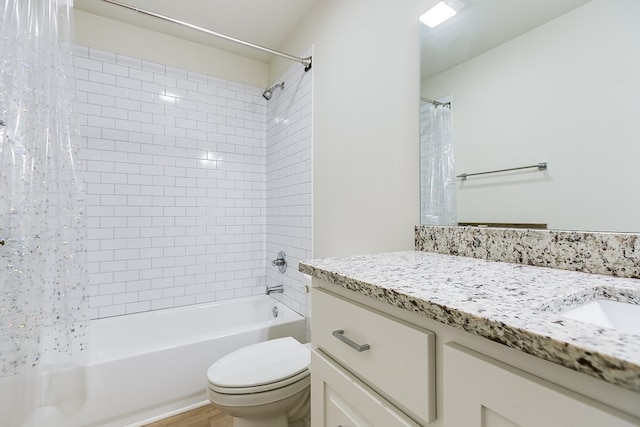 full bathroom featuring vanity, shower / bath combination with curtain, and toilet