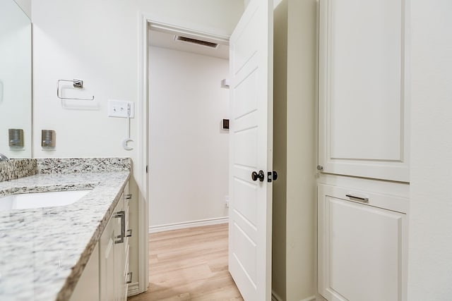 bathroom featuring vanity and hardwood / wood-style floors