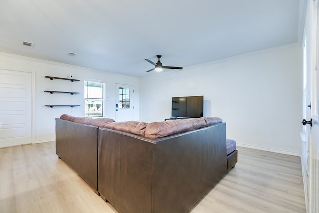 living room featuring crown molding, light hardwood / wood-style flooring, and ceiling fan