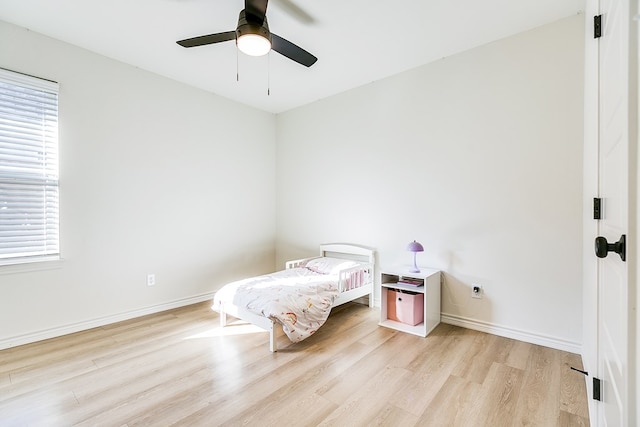 bedroom with ceiling fan and light wood-type flooring