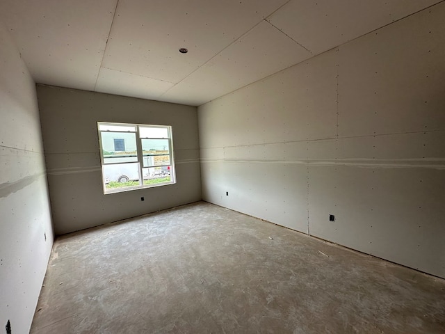 spare room with concrete floors
