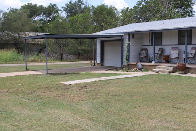 view of yard featuring a carport, a garage, and covered porch