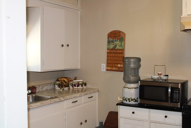 kitchen featuring sink and white cabinets