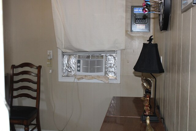 bathroom featuring cooling unit and wood walls