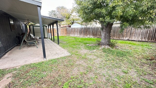 view of yard featuring ceiling fan and a patio area