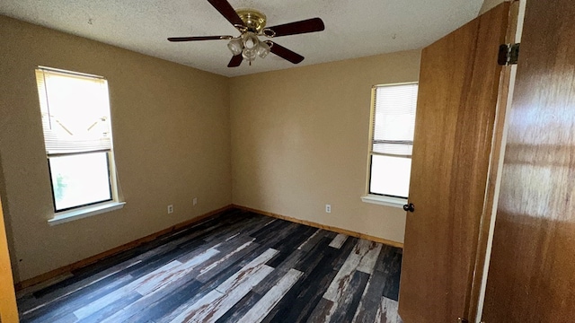 unfurnished room with dark wood-type flooring and ceiling fan