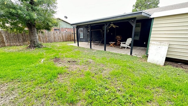 view of yard featuring ceiling fan and a patio area