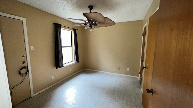 empty room with a textured ceiling and ceiling fan