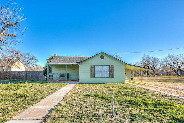 ranch-style house with a front yard and a carport