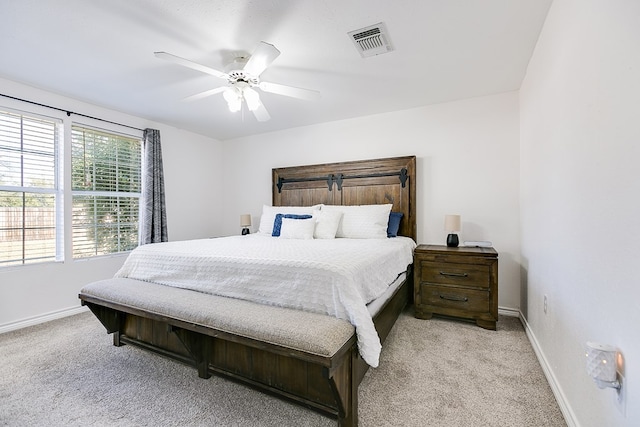 bedroom featuring light colored carpet and ceiling fan