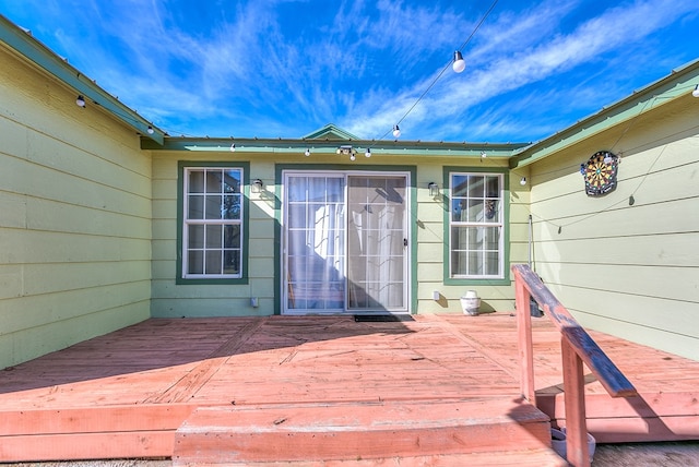 view of exterior entry with a deck