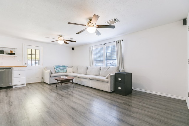 living room featuring dark hardwood / wood-style flooring and a textured ceiling