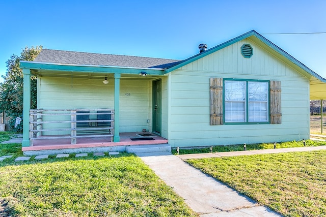 ranch-style house with a front lawn and a porch