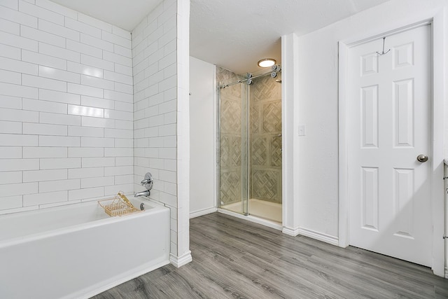 bathroom featuring hardwood / wood-style flooring and a textured ceiling