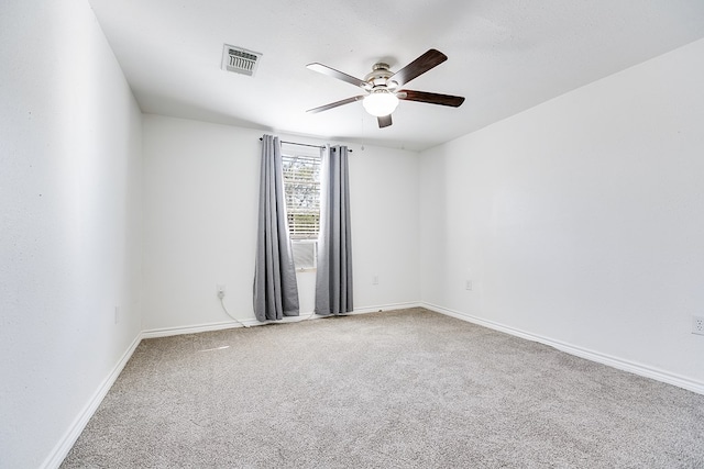 empty room with ceiling fan and carpet