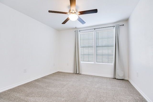 empty room with light colored carpet and ceiling fan