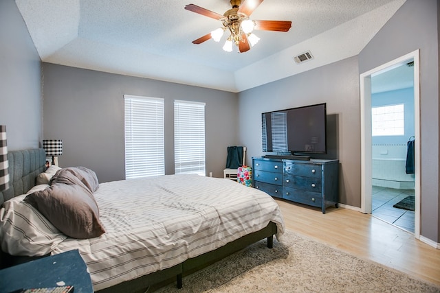 3118 Grandview Dr, San Angelo, TX 76904 - bedroom featuring light wood finished floors, a textured ceiling, ceiling fan, and ensuite bathroom