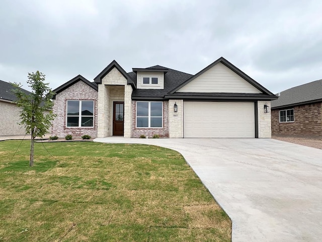 3962 Ruth Ln, San Angelo, TX 76904 - view of front of property featuring a garage, concrete driveway, a front lawn, and stone siding