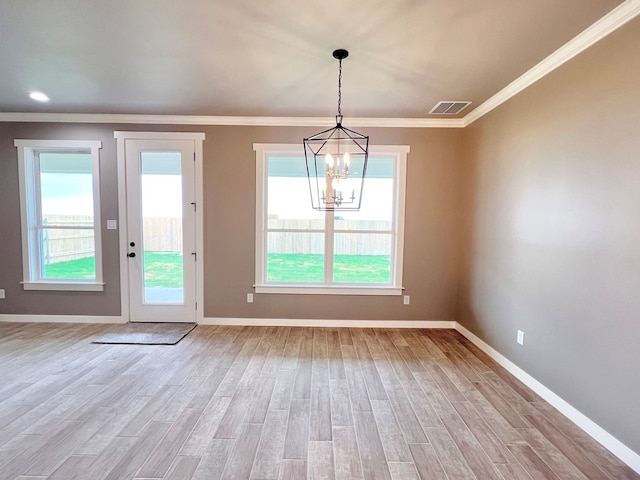 3962 Ruth Ln, San Angelo, TX 76904 - unfurnished dining area with light wood-type flooring, a chandelier, baseboards, and ornamental molding
