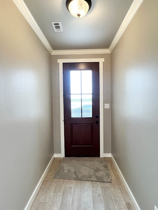3962 Ruth Ln, San Angelo, TX 76904 - doorway to outside with light wood-style floors, ornamental molding, and baseboards