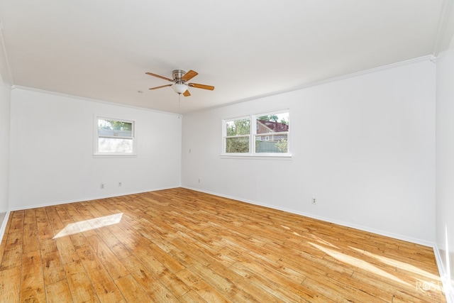 unfurnished room with a ceiling fan, baseboards, light wood finished floors, and crown molding