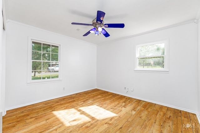 empty room featuring a ceiling fan, light wood-style flooring, baseboards, and ornamental molding