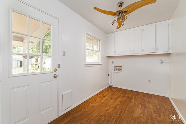 laundry area featuring baseboards, washer hookup, cabinet space, and wood finished floors