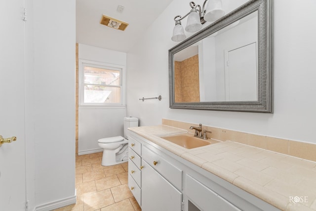 bathroom with toilet, tile patterned floors, and vanity