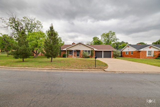 ranch-style house featuring a chimney, brick siding, an attached garage, concrete driveway, and a front yard