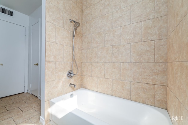 full bath with  shower combination and visible vents