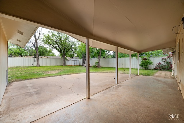 view of patio / terrace featuring an outdoor structure, a fenced backyard, and a shed