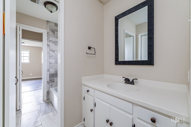 full bathroom featuring baseboards, visible vents, and vanity