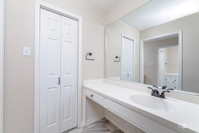 bathroom featuring vanity and a closet