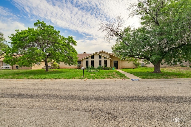 mid-century inspired home with a front lawn