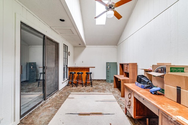 interior space with ceiling fan, vaulted ceiling, and a dry bar