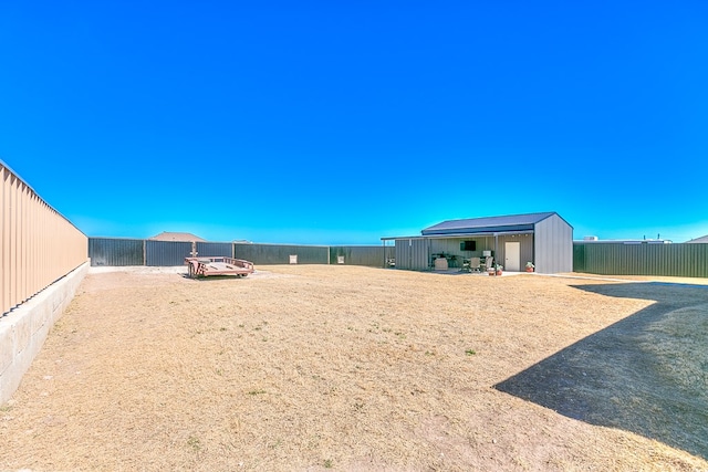 view of yard with an outbuilding and a fenced backyard