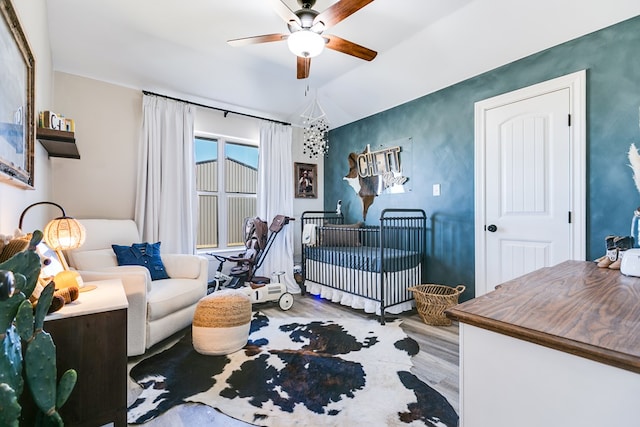 bedroom with light wood finished floors and ceiling fan